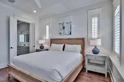 a bedroom with a large bed and two lamps at Southern Serenity Cottage in Rosemary Beach