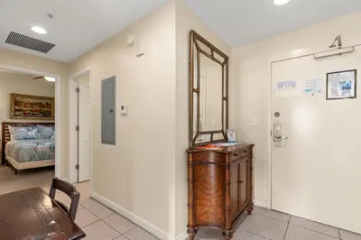 a room with a table and a room with a bed at Beachfront Bliss Awaits: 2-Bed, 2-Bath Condo at Sterling Reef - Sleeps 6! in Panama City Beach