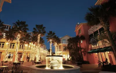 a courtyard with palm trees and a fountain with lights at Beachfront Bliss Awaits: 2-Bed, 2-Bath Condo at Sterling Reef - Sleeps 6! in Panama City Beach