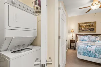 a bathroom with a sink and a bed in a room at Beachfront Bliss Awaits: 2-Bed, 2-Bath Condo at Sterling Reef - Sleeps 6! in Panama City Beach