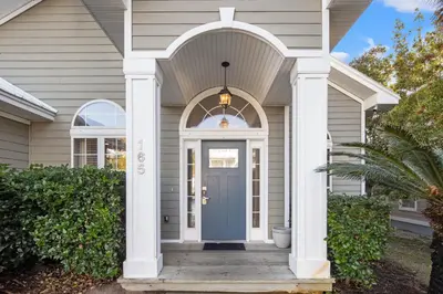 a front door of a house with a blue door at Sugar Sand Retreat – 3-Bed, 2-Bath Beach Getaway with Private Pool, Sleeps 8! in Santa Rosa Beach
