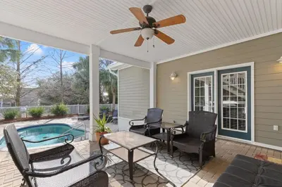 a patio with chairs and a table and a ceiling fan at Sugar Sand Retreat – 3-Bed, 2-Bath Beach Getaway with Private Pool, Sleeps 8! in Santa Rosa Beach