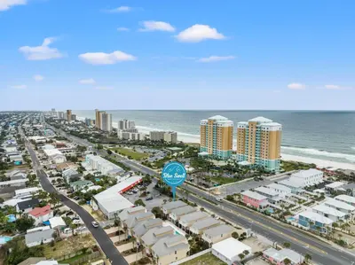 an aerial view of a city and the ocean at Escape to Sand Dollar Holler: Coastal Retreat, 3 Beds, 25 Baths, Sleeps 10! in Panama City Beach