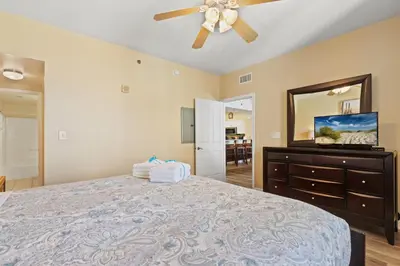a bedroom with a bed and a ceiling fan at Shores of Panama 1217 | Emerald Beach Retreat in Panama City Beach