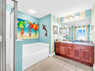 a bathroom with a tub and a sink at Aqua Resort 706 in Panama City Beach