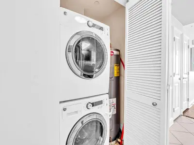 a laundry room with a washer and dryer at Aqua Resort 706 in Panama City Beach
