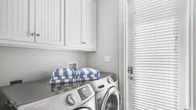 a washer and dryer in a laundry room with at 30A Emerald Waters by AvantStay Pool Bikes Bonfires in Panama City Beach