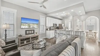 a living room with a couch and a table at 30A Emerald Waters by AvantStay Pool Bikes Bonfires in Panama City Beach