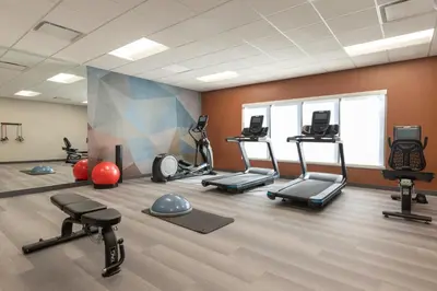a gym with several treadmills and exercise machines at Candlewood Suites Panama City - Tyndall AFB by IHG in Panama City