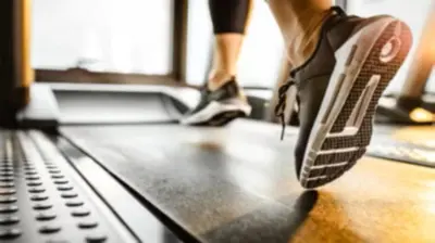 a person walking on a treadmill next to a laptop at Candlewood Suites Panama City - Tyndall AFB by IHG in Panama City