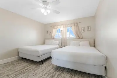 a bedroom with two beds and a ceiling fan at Regency Towers 1212 by Emerald Coast Retreats in Panama City Beach