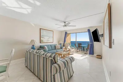 a living room with a couch and a table at Regency Towers 1212 by Emerald Coast Retreats in Panama City Beach