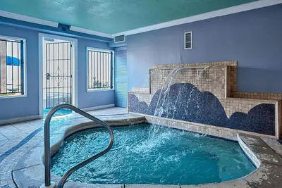 a hot tub with a waterfall in a house at Regency Towers 1212 by Emerald Coast Retreats in Panama City Beach