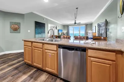 a kitchen with a sink and a dishwasher at Grandview East 1002 in Panama City Beach