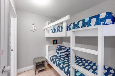 a bedroom with two bunk beds in a room at Laketown Wharf #1219 by Nautical Properties in Panama City Beach