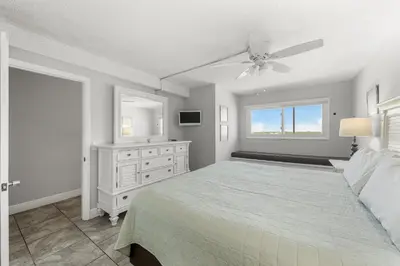 a bedroom with a bed and a ceiling fan at Summit #1105 by Nautical Properties Vacation Rentals in Panama City Beach