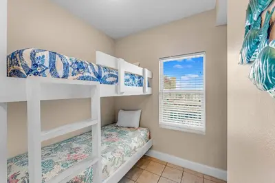 a bedroom with two bunk beds and a window at Laketown Wharf #1531 by Nautical Properties in Panama City Beach