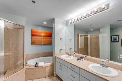 a bathroom with two sinks and a shower and a tub at Laketown Wharf #1531 by Nautical Properties in Panama City Beach