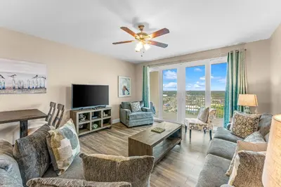 a living room with a couch and a tv at Laketown Wharf #1531 by Nautical Properties in Panama City Beach