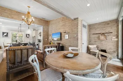 a dining room with a wooden table and chairs at 67 Wiggle Lane - Rosemary Beach - Steps to Tennis Courts, Beach, Pools! in Rosemary Beach