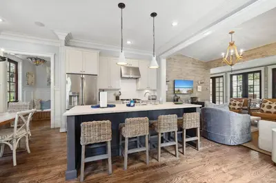 an open kitchen and living room with a large island at 67 Wiggle Lane - Rosemary Beach - Steps to Tennis Courts, Beach, Pools! in Rosemary Beach