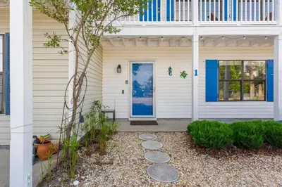 a front door of a house with a blue door at Casa de Tortugas - a spacious townhome with 30a private beach access in Seacrest