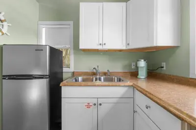 a kitchen with a sink and a refrigerator at Making Memories in Panama City Beach