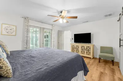 a bedroom with a bed and a ceiling fan at Making Memories in Panama City Beach