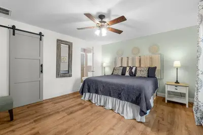 a bedroom with a bed and a ceiling fan at Making Memories in Panama City Beach