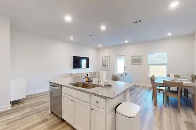 a kitchen and dining room with a sink and a table at Steps to Sand and Surf! Family-Friendly PCB Retreat in Panama City Beach