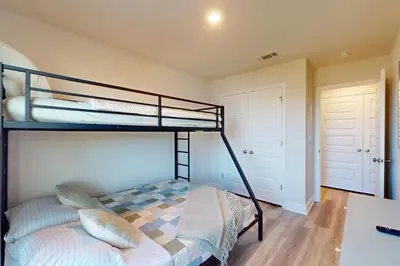 a bedroom with two bunk beds in a room at Steps to Sand and Surf! Family-Friendly PCB Retreat in Panama City Beach