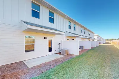 a large white building with a row of stalls at Steps to Sand and Surf! Family-Friendly PCB Retreat in Panama City Beach