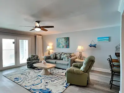 a living room with a couch and a table at Mariner East #602 in Panama City Beach
