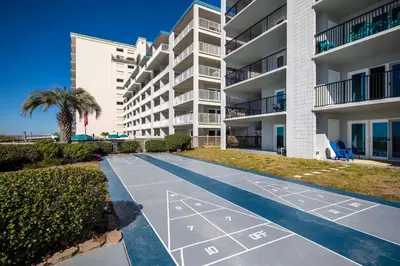 an empty pathway in front of a apartment building at Mariner East #602 in Panama City Beach