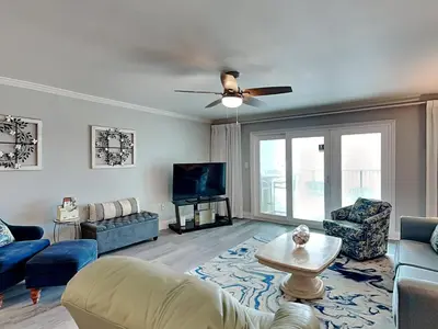 a living room with a couch and a tv at Mariner East #602 in Panama City Beach