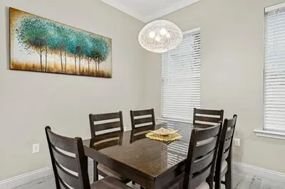 a dining room with a wooden table and chairs at Spacious 4-Bed, 3-Bath Beach House – Sleeps 12 for the Perfect Getaway in Panama City Beach
