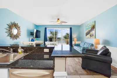 a kitchen and living room with a large counter top at Calypso 203 1 Bedroom Gulf Front in Panama City Beach