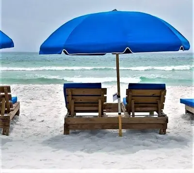 two chairs and an umbrella on the beach at Calypso 203 1 Bedroom Gulf Front in Panama City Beach