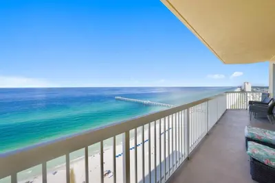 a balcony with a view of the ocean at Calypso 2109 West Corner Unit with incredible gulf views for miles in Panama City Beach