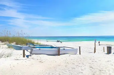 a group of boats sitting on the beach at Calypso 2109 West Corner Unit with incredible gulf views for miles in Panama City Beach
