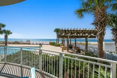a view of the beach from the balcony of a resort at Aqua 110 New Remodel Ground Level, The most Requested Unit in Building in Panama City Beach