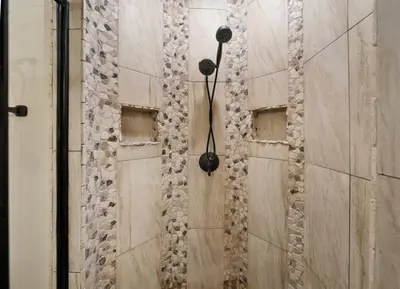 a shower with a stone wall with windows at Aqua 110 New Remodel Ground Level, The most Requested Unit in Building in Panama City Beach