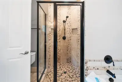 a shower with a glass door in a bathroom at Aqua 110 New Remodel Ground Level, The most Requested Unit in Building in Panama City Beach