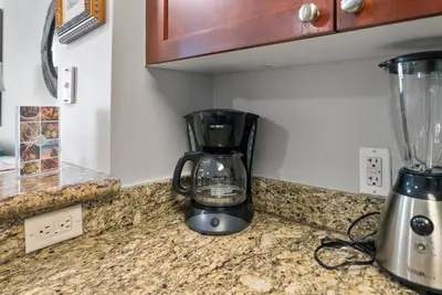 a blender sitting on top of a kitchen counter at Aqua 110 New Remodel Ground Level, The most Requested Unit in Building in Panama City Beach