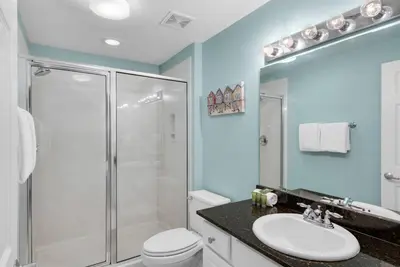 a bathroom with a shower and a toilet and a sink at 2007 Calypso East 1 Bedroom in Panama City Beach