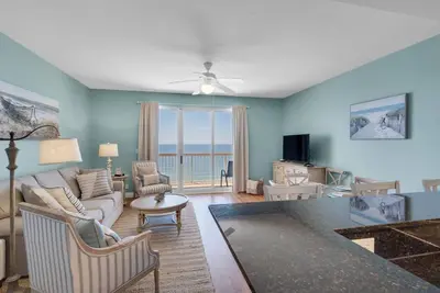 a living room with a couch and a table at 2007 Calypso East 1 Bedroom in Panama City Beach