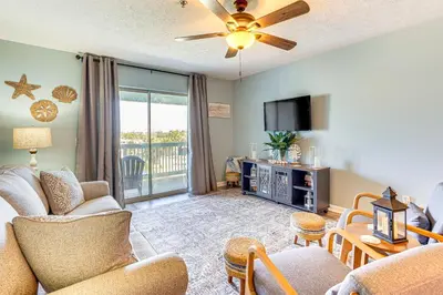 a living room with a couch and a tv at Walk to Beach Condo with Balcony in PCB! in Panama City Beach