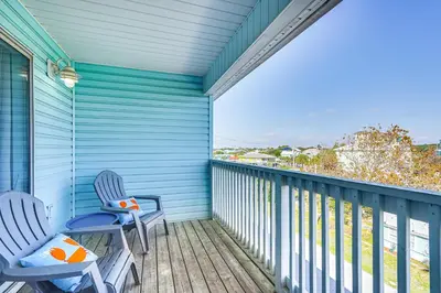 two chairs on a balcony with a view of the ocean at Walk to Beach Condo with Balcony in PCB! in Panama City Beach