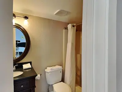 a bathroom with a toilet and a sink and a mirror at Edgewater Tower II 2 in Panama City Beach