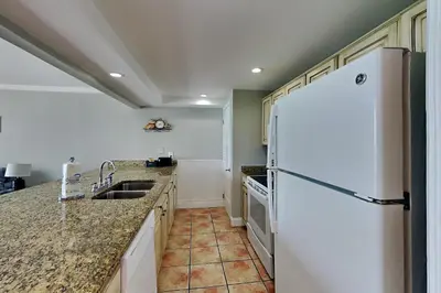 a kitchen with a refrigerator and a sink at Edgewater Tower II 2 in Panama City Beach